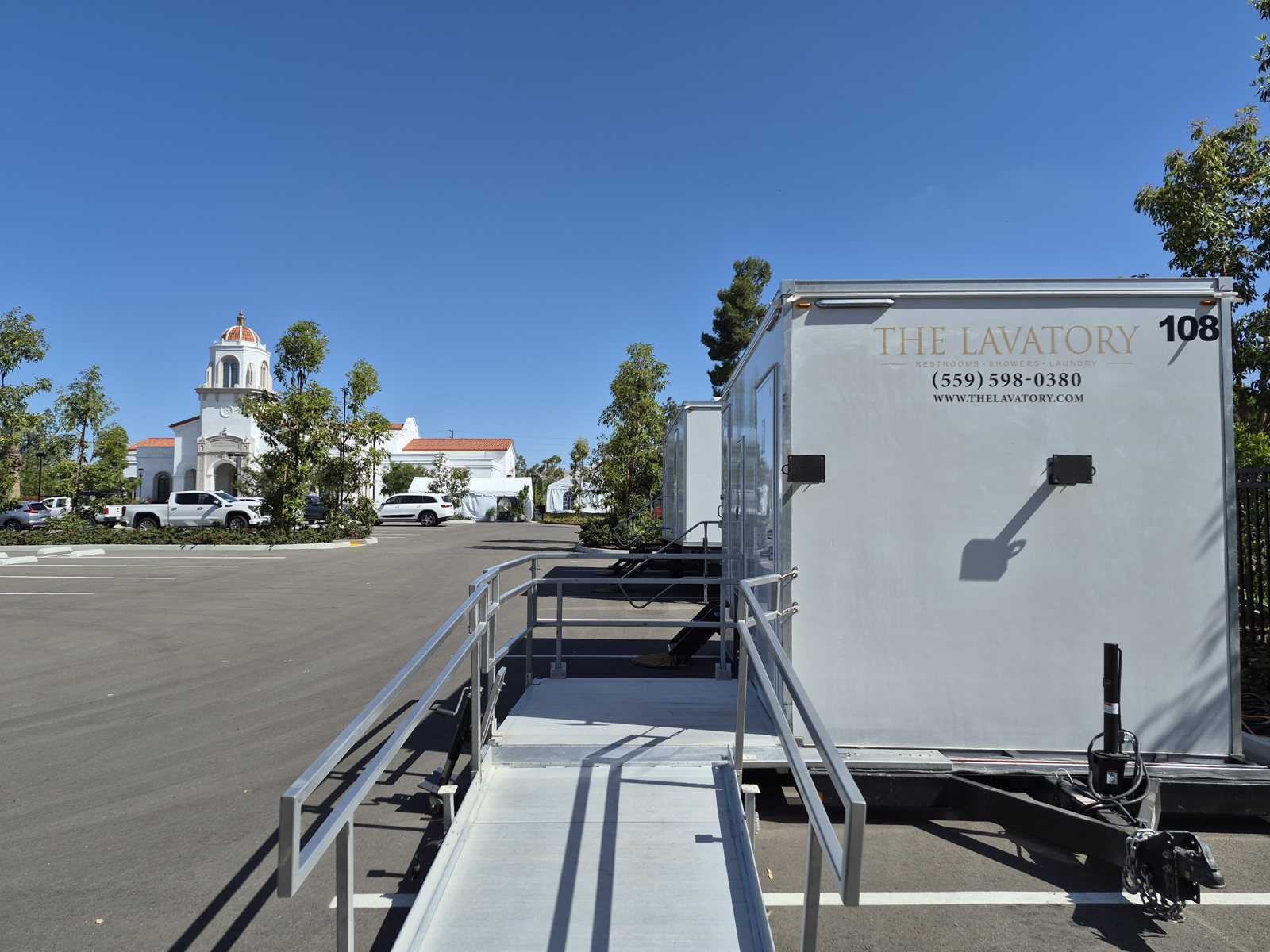 An ADA restroom trailer from The Lavatory with its ramp deployed, set up for a site in Fresno, California