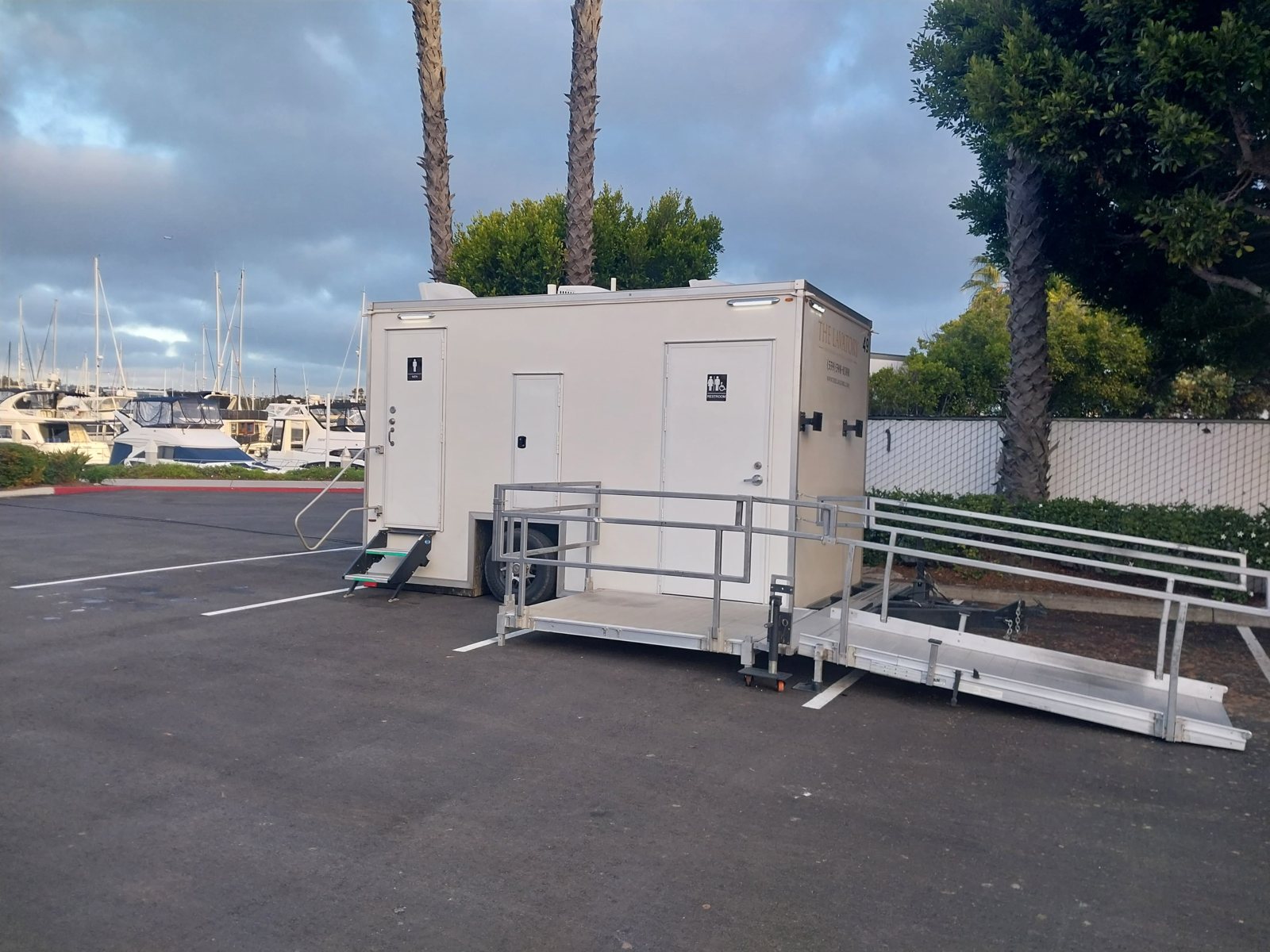 An ADA restroom trailer from The Lavatory with its ramp deployed, set up for a site in Oakland, California