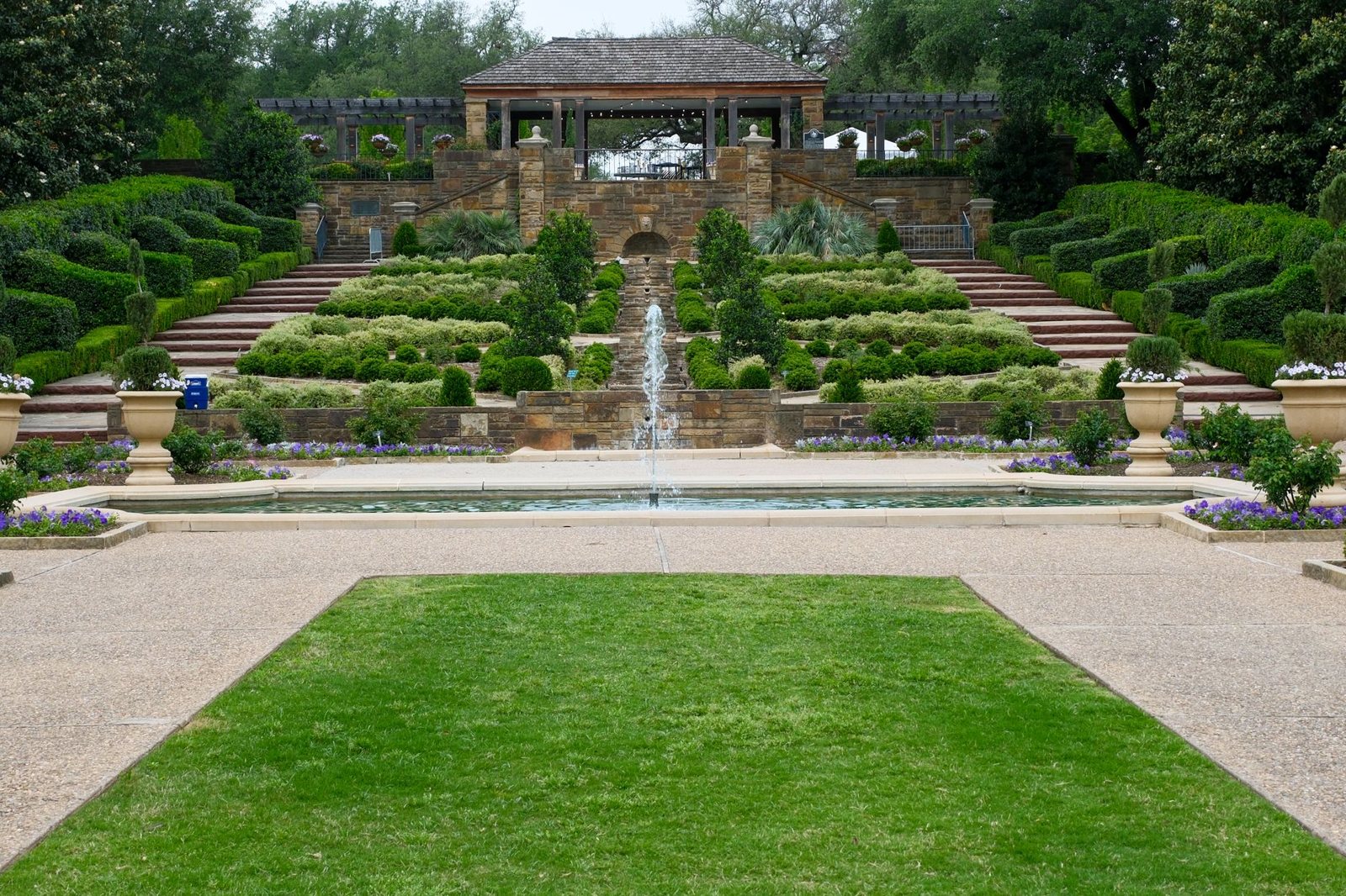 Terraced lawns, hedges and a long fountain at a formal garden in Fort Worth, Texas