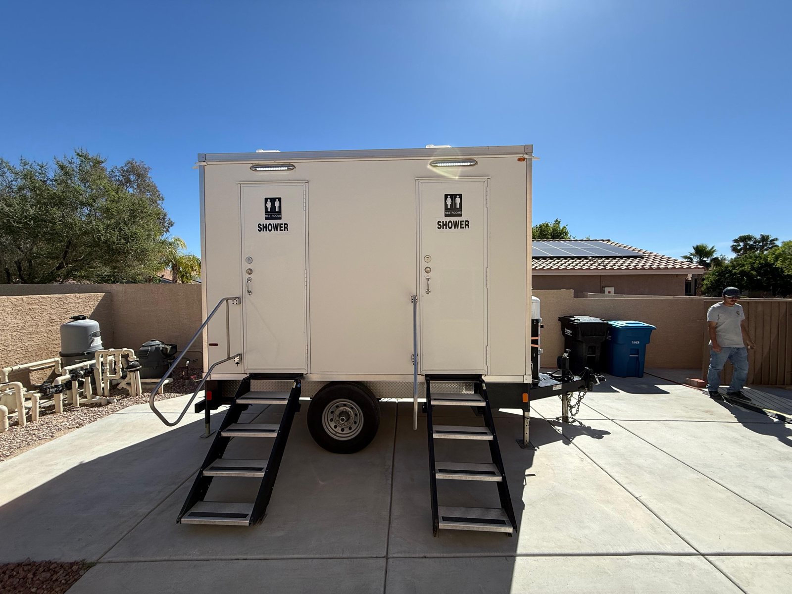 An 8-station private shower trailer from The Lavatory set up on a job in Orem, Utah, hot water and climate control inside